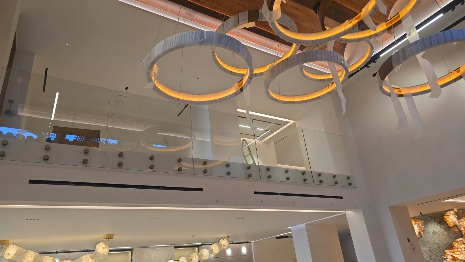 Golden light rings on a wood ceiling