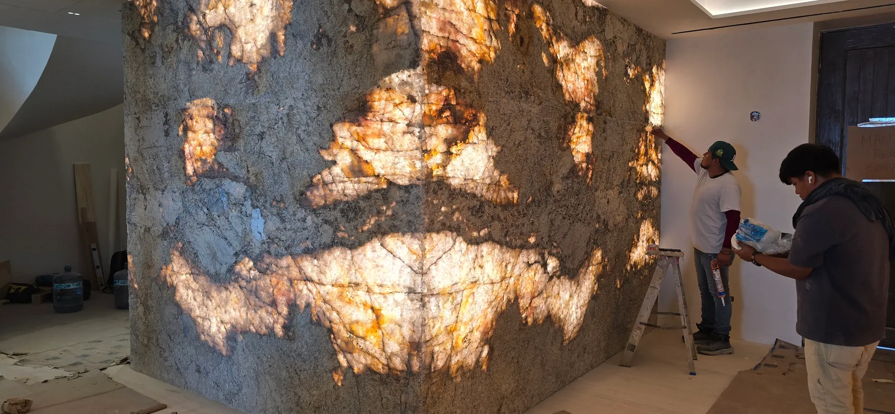 Backlit onyx wall on site